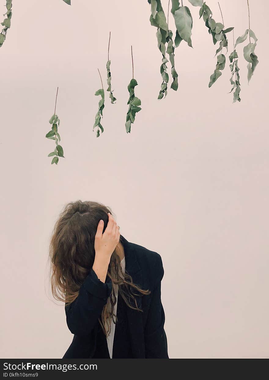 Woman Wearing Black Blazer Beside White Wall