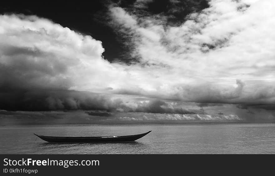 Grayscale Photo of Black Boat