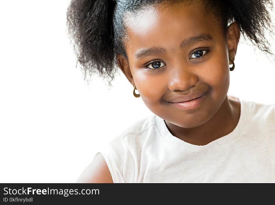 Macro close up portrait of attractive little ponytailed african girl.Isolated on white background. Macro close up portrait of attractive little ponytailed african girl.Isolated on white background.