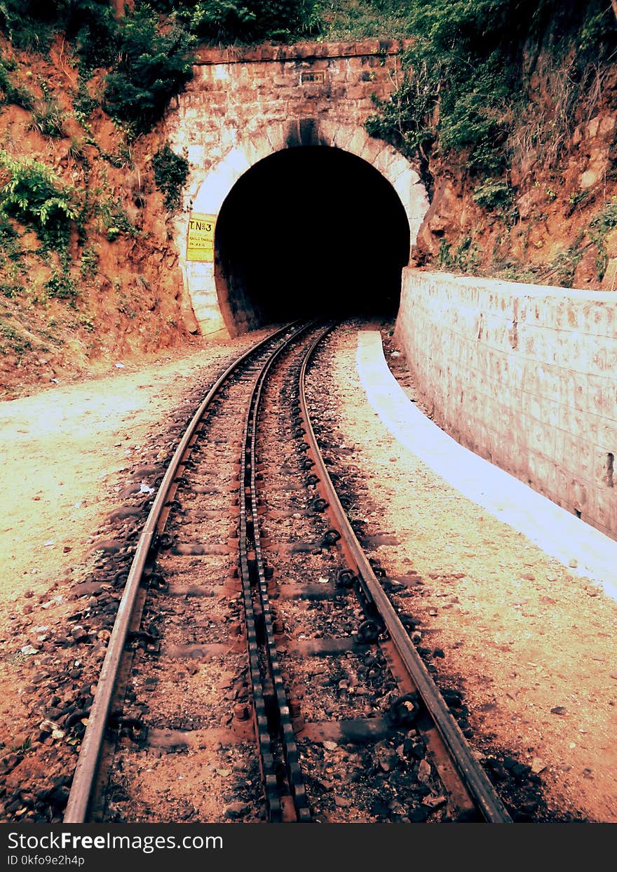 Train track leading to tunnel