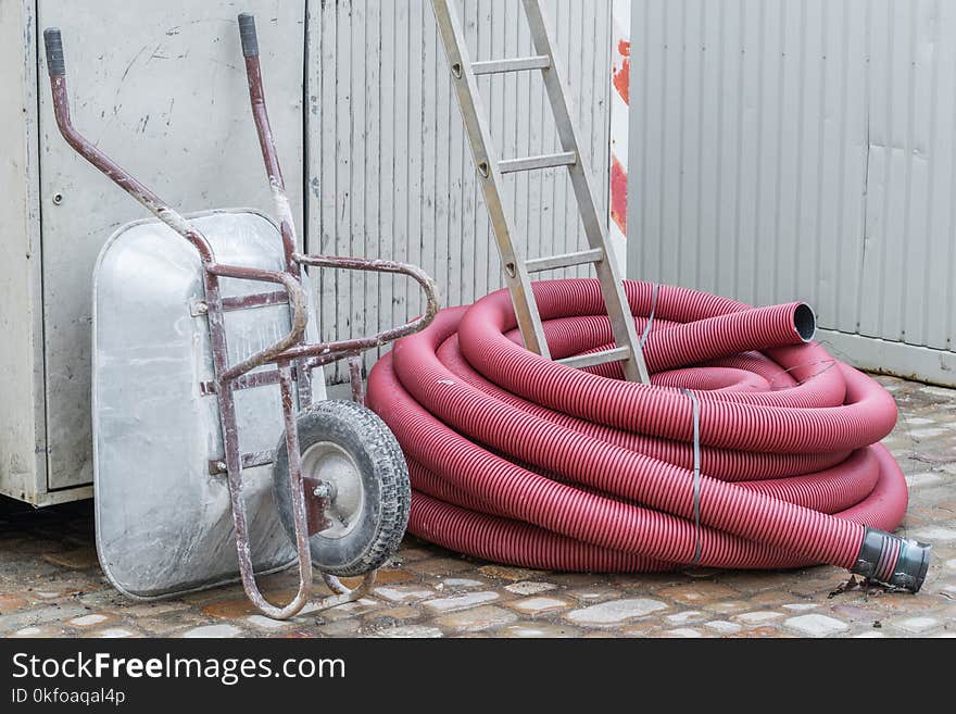 Construction Site With Wheelbarrow Ladder And Plastic Pipe, Germany