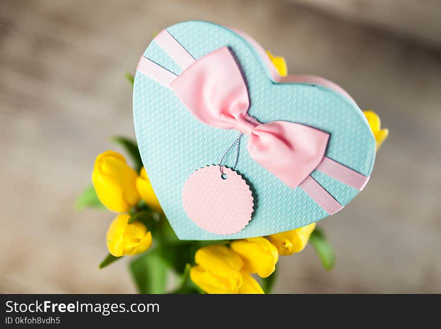 Yellow tulips on wooden background