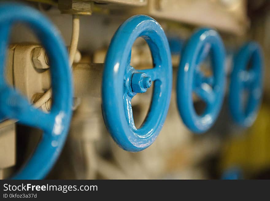 Closeup of blue metal valves on engineering construction