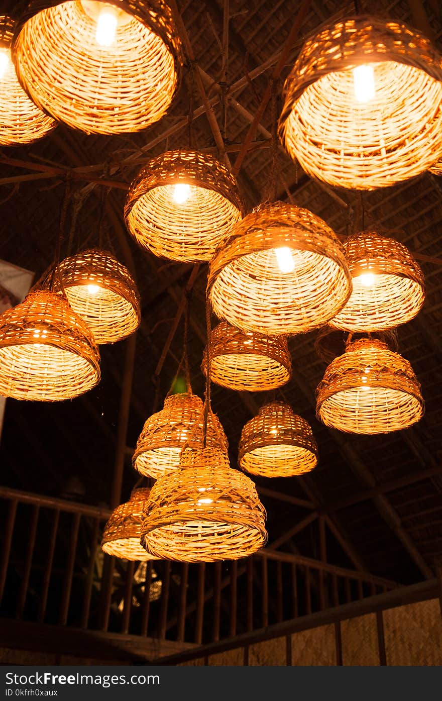 Illuminated rustic simple desing woven bamboo lamps hang from ceiling. Illuminated rustic simple desing woven bamboo lamps hang from ceiling