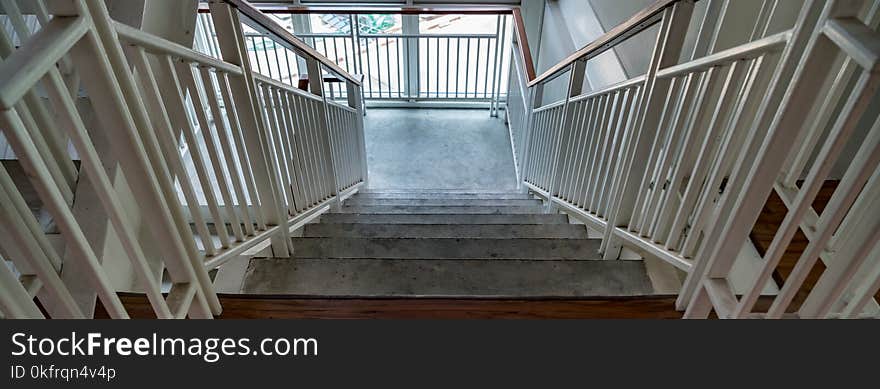 White iron railing on wooden stair