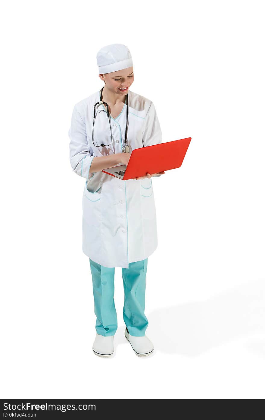 Beautiful young woman in white coat posing at studio with red laptop. Full length shot isolated on white background. Healthcare, doctor, medical, health concept. Caucasian female model. Beautiful young woman in white coat posing at studio with red laptop. Full length shot isolated on white background. Healthcare, doctor, medical, health concept. Caucasian female model