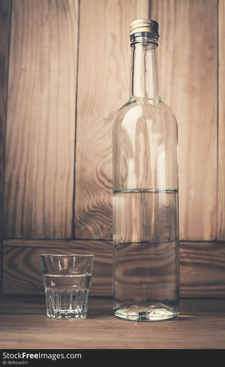 Vodka on a wood background.