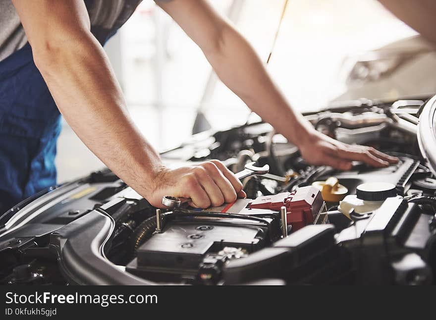 Auto mechanic working in garage. Repair service