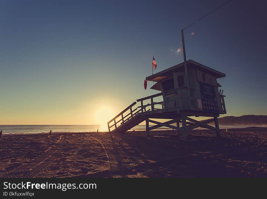 Sunset on the beach with lifeguard stand in Los Angeles, California, United States. Sunset on the beach with lifeguard stand in Los Angeles, California, United States