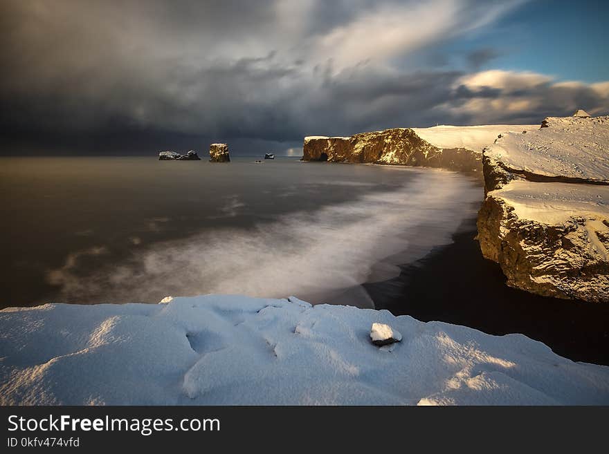 Dyrholaey cape over black sand beach in Iceland