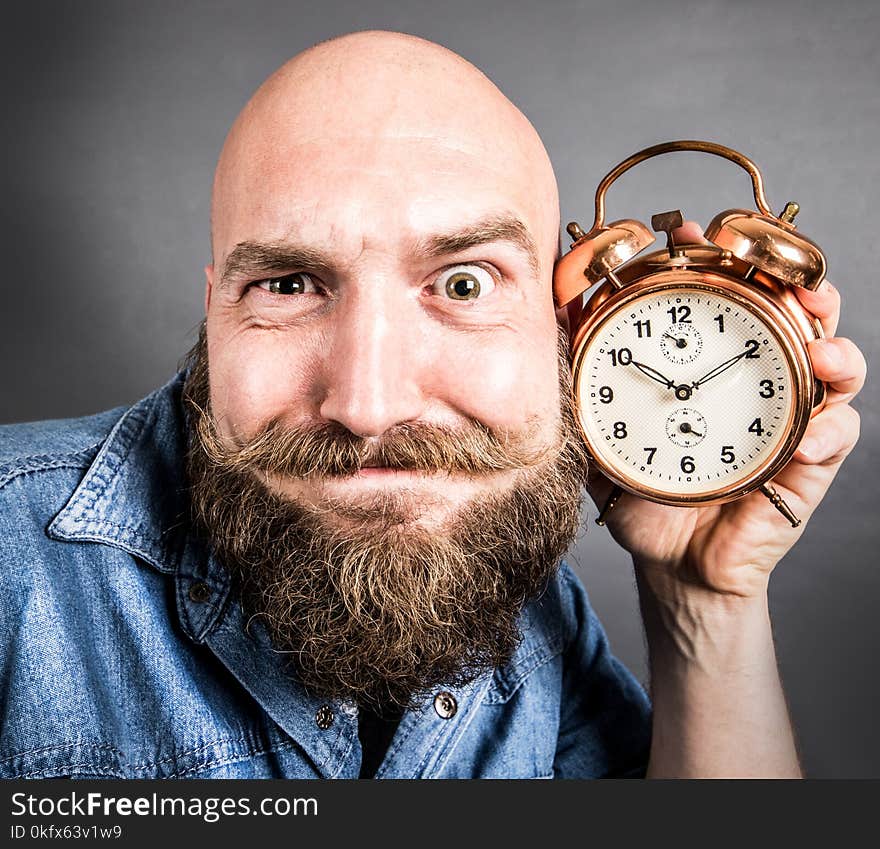 An expressive man with alarm clock