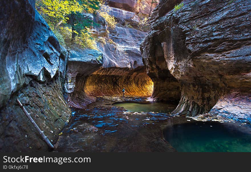 A man standing at the Subway, Zion National park with light tunnel