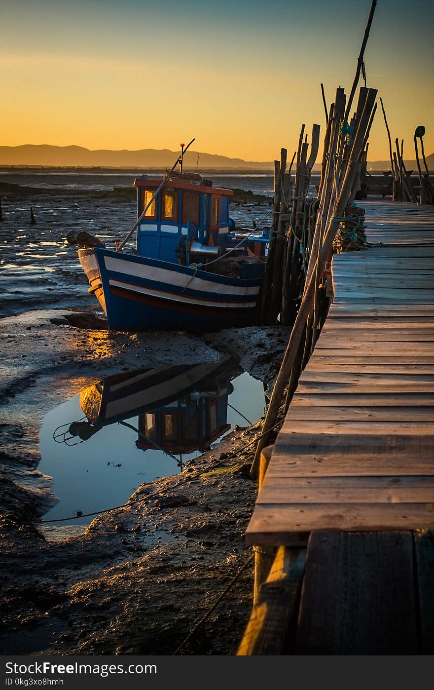 Sunset view of Carrasqueira palaffitic port with old boats in Portugal. Sunset view of Carrasqueira palaffitic port with old boats in Portugal