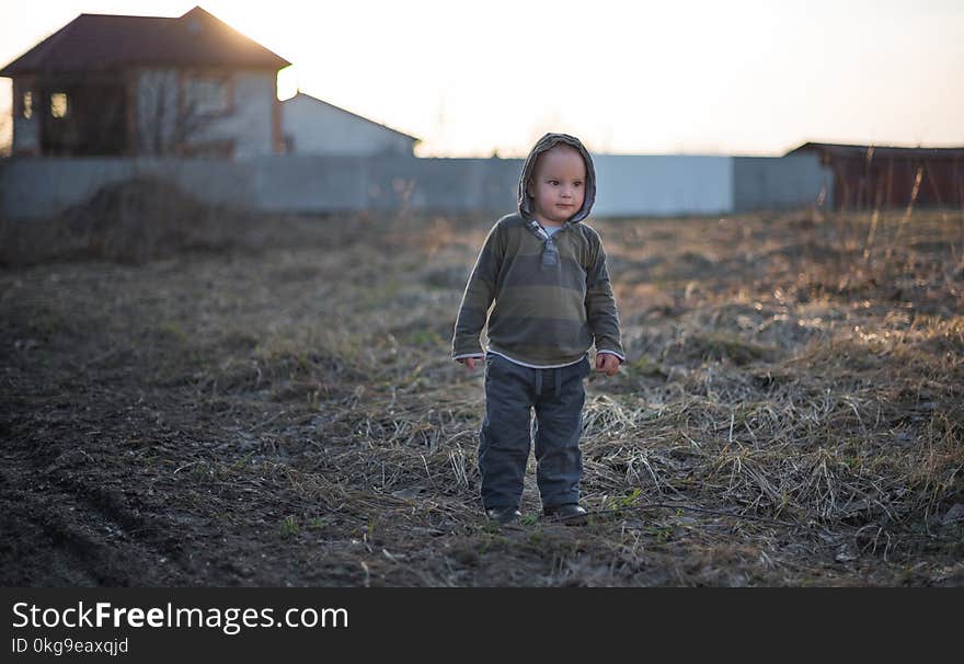 The little two-year-old boy walks outdoors. The little two-year-old boy walks outdoors