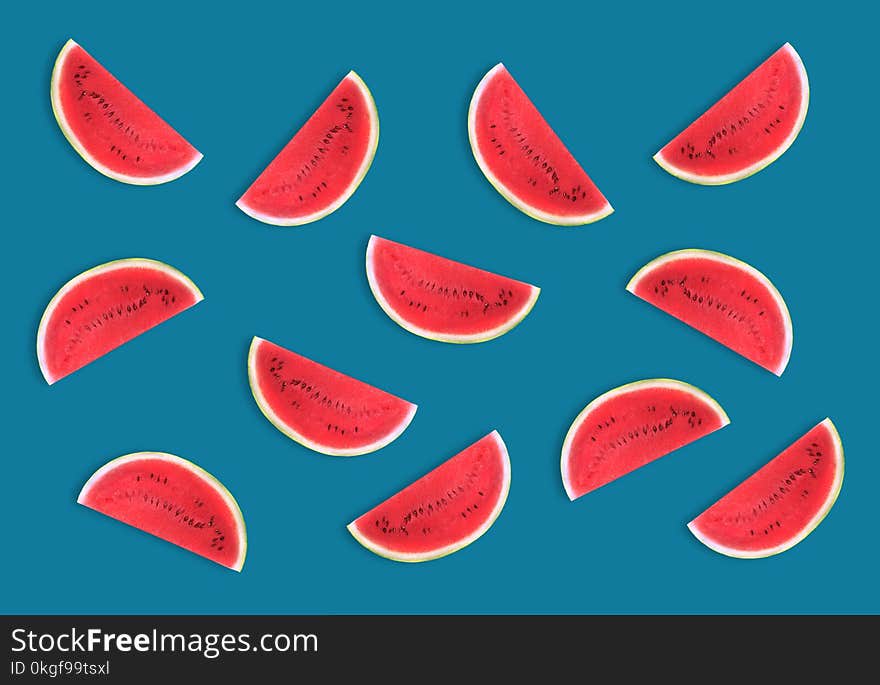 Colorful fruit pattern of fresh watermelon slices on blue background. From top view. Colorful fruit pattern of fresh watermelon slices on blue background. From top view