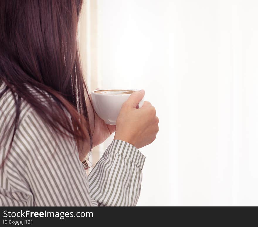 Photo of Woman Holding Cup of Coffee