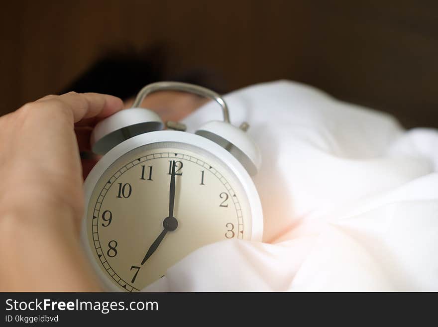 Photo of Person Holding Alarm Clock