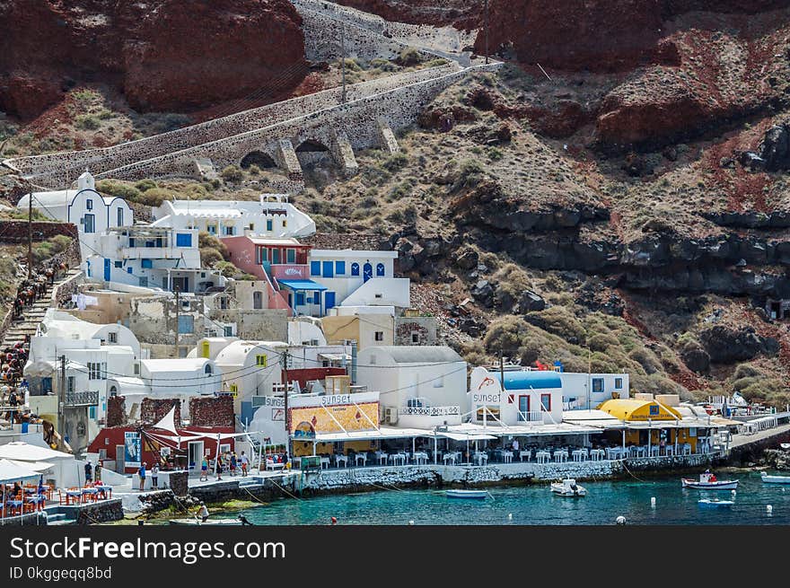 White and Blue Houses Beside Body of Water