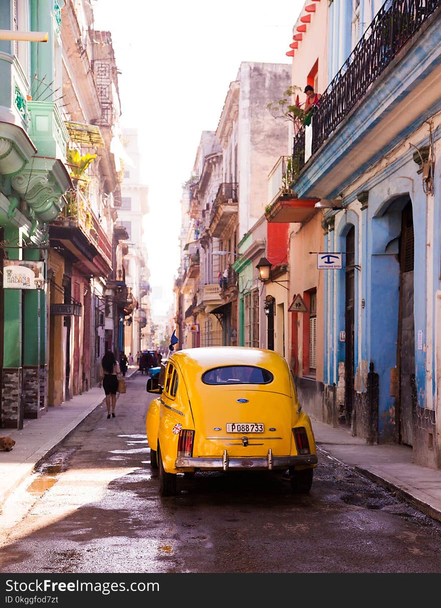 Photography of Yellow Car on Alley