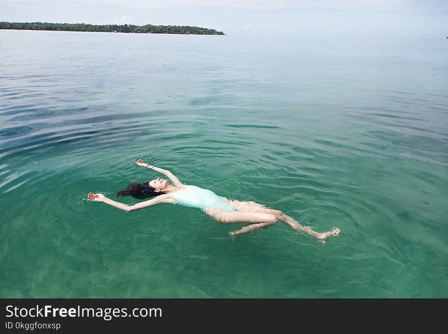 Photography of a Woman Floating on Water