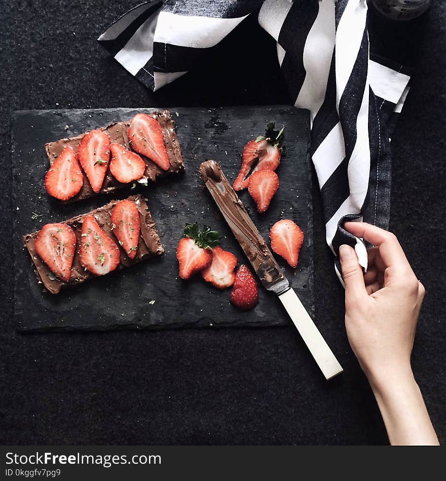 Slices Strawberries on Chopping Board