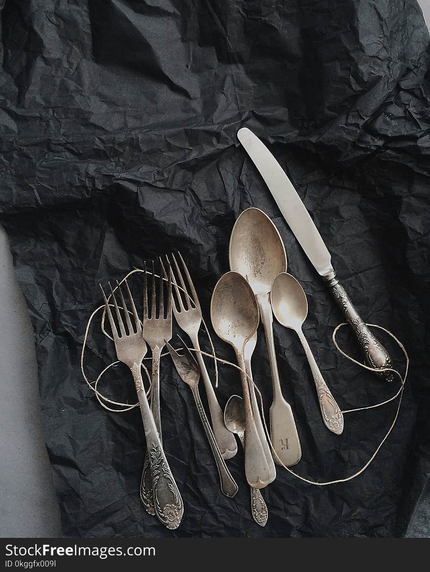 Photo of Stainless Steel Cutlery on Black Cloth