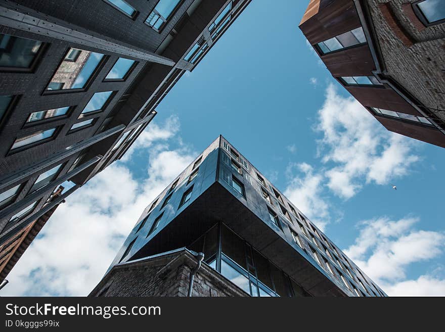 Low Angle Photo of Skyscrapers Under White Cloudy Sky