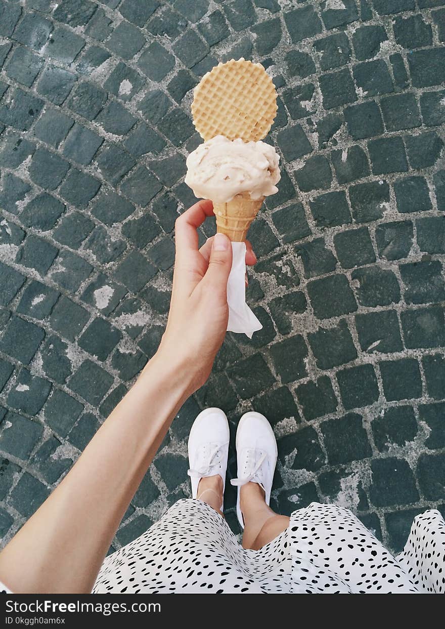 Person Holding Ice Cream in Cone