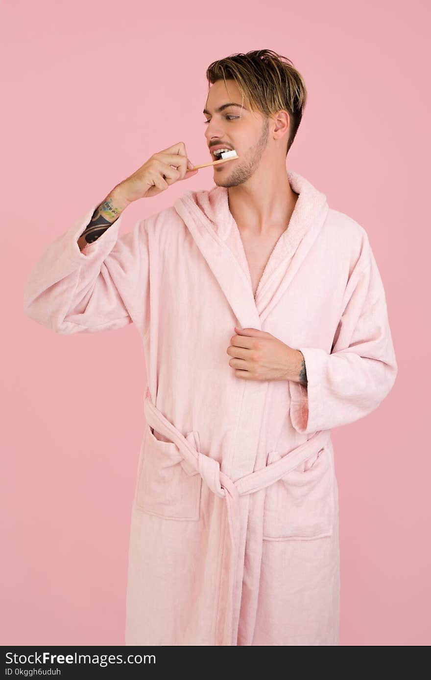 Man Wearing Bathrobe Brushing His Teeth