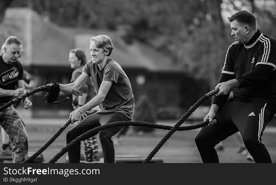 Grayscale Photography of Two Men Using Exercise Ropes