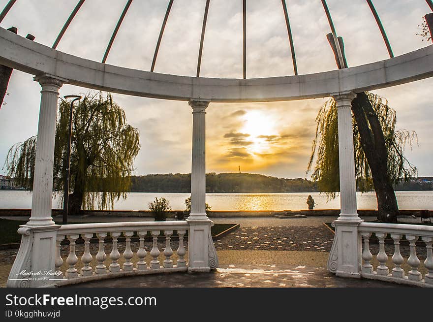 Person Standing Beside Body of Water