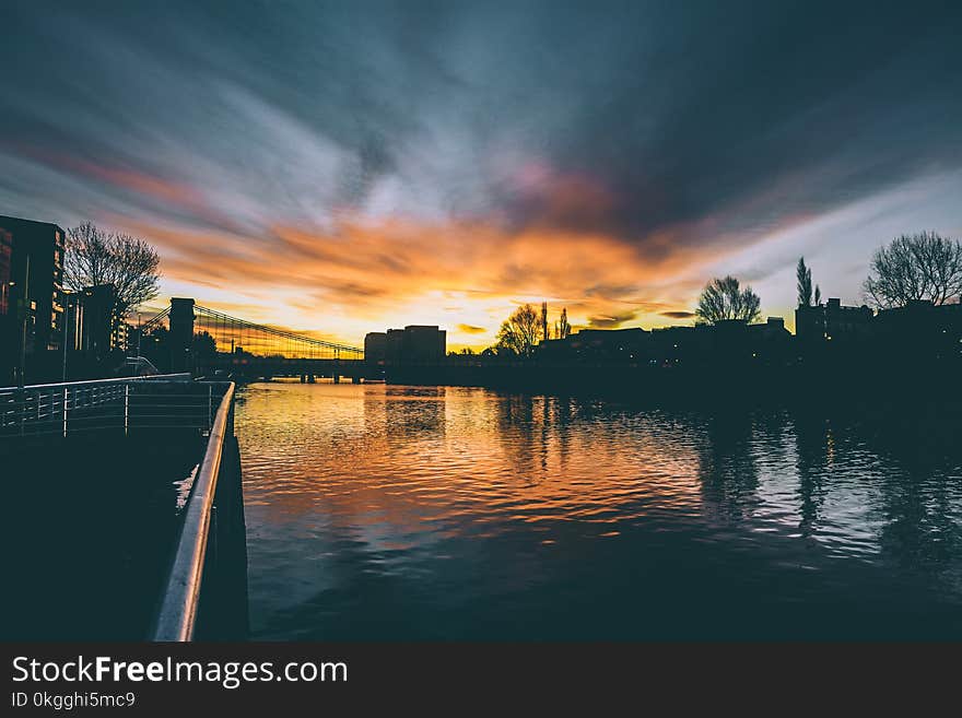 High Rise Buildings Near Body of Water during Golden Hour