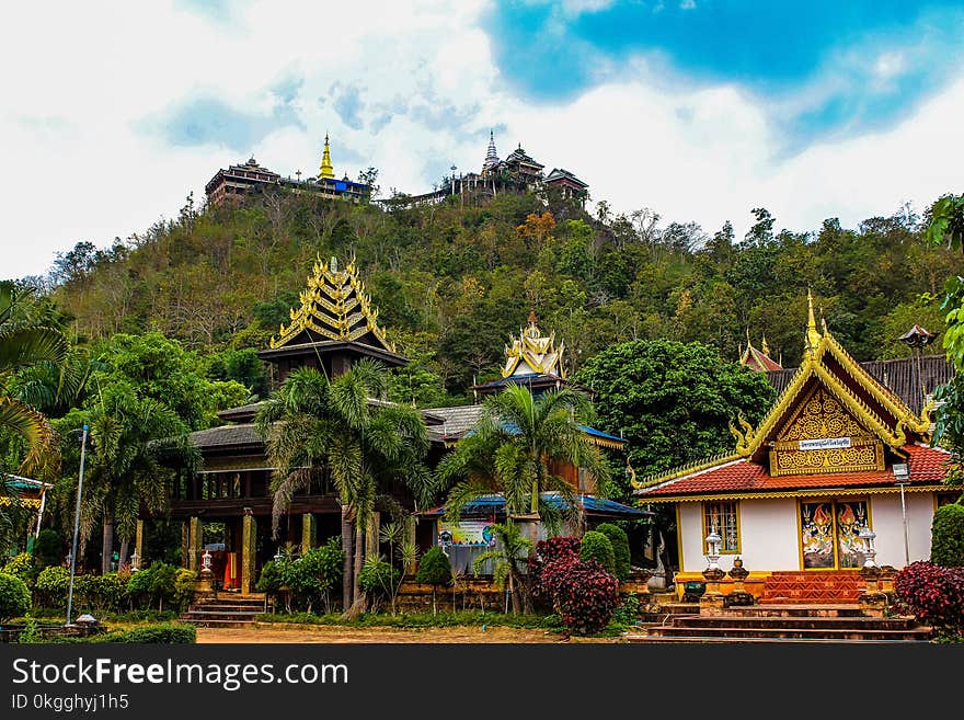 White and Orange Pagoda Near the Mountain