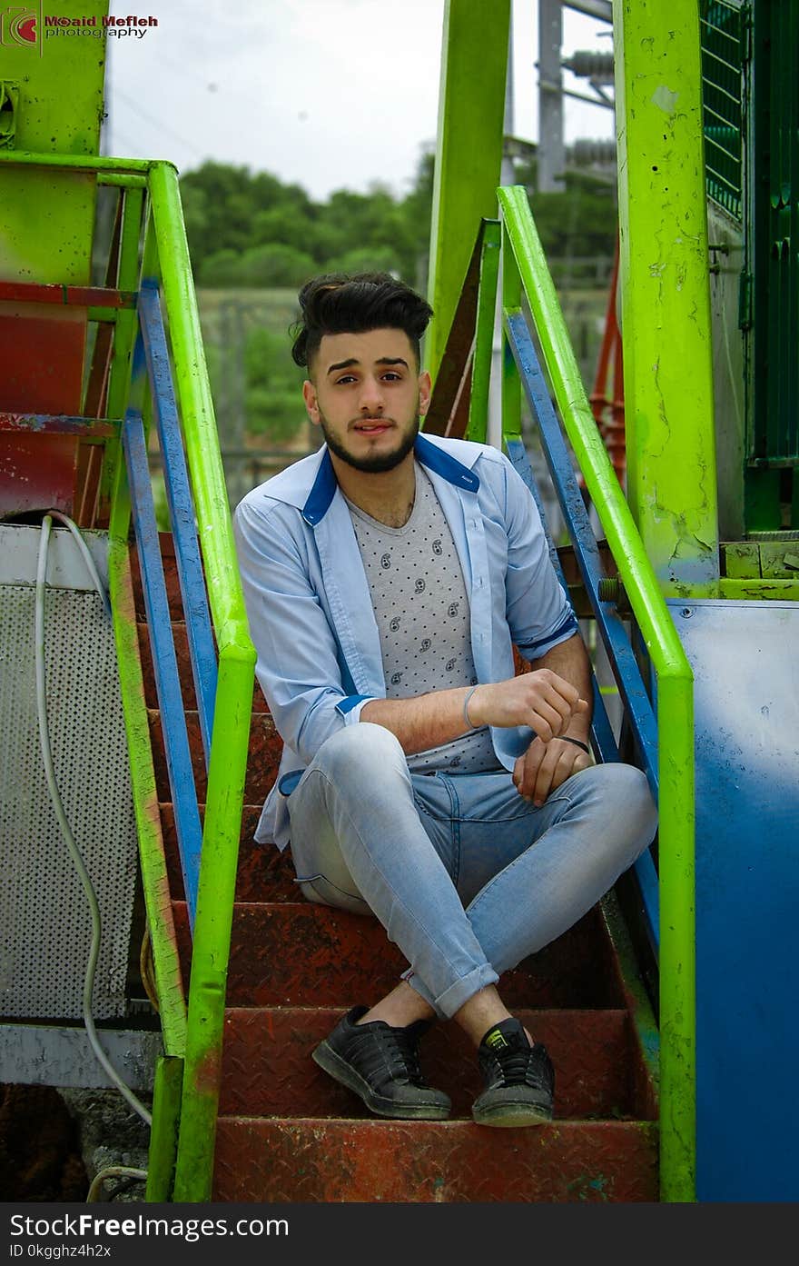 Man Wears Blue Dress Shirt Sitting on the Stair