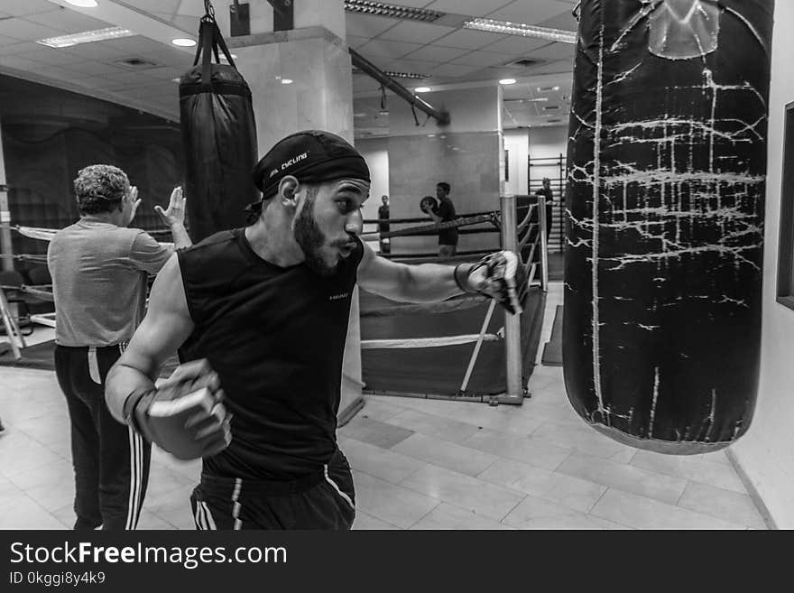 Person Beside Black Leather Heavy Bag