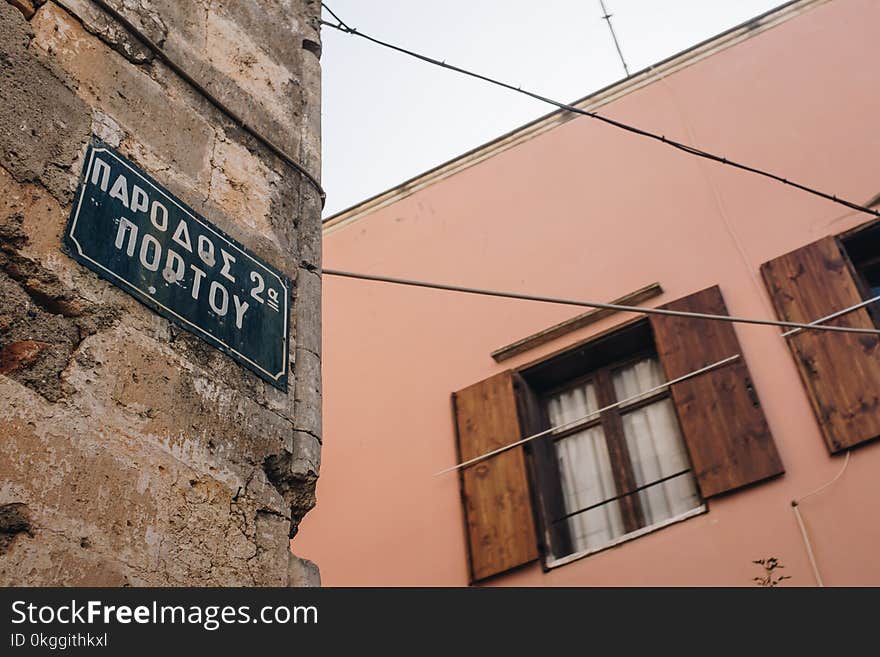 Low Angle Photo of Alley With Signage on Brick Wall