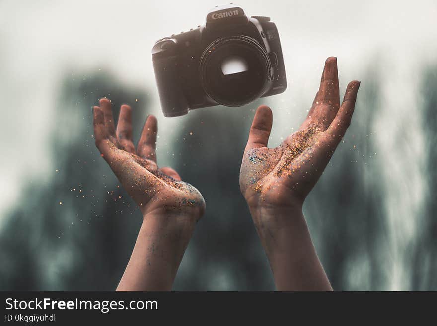 Selevtice Photography of Black Canon Dslr Camera Above Human Hands