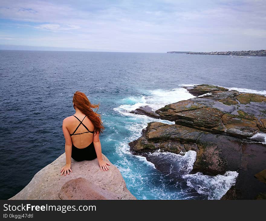 Woman Wearing Monokini on Rock Cliff Near Body of water