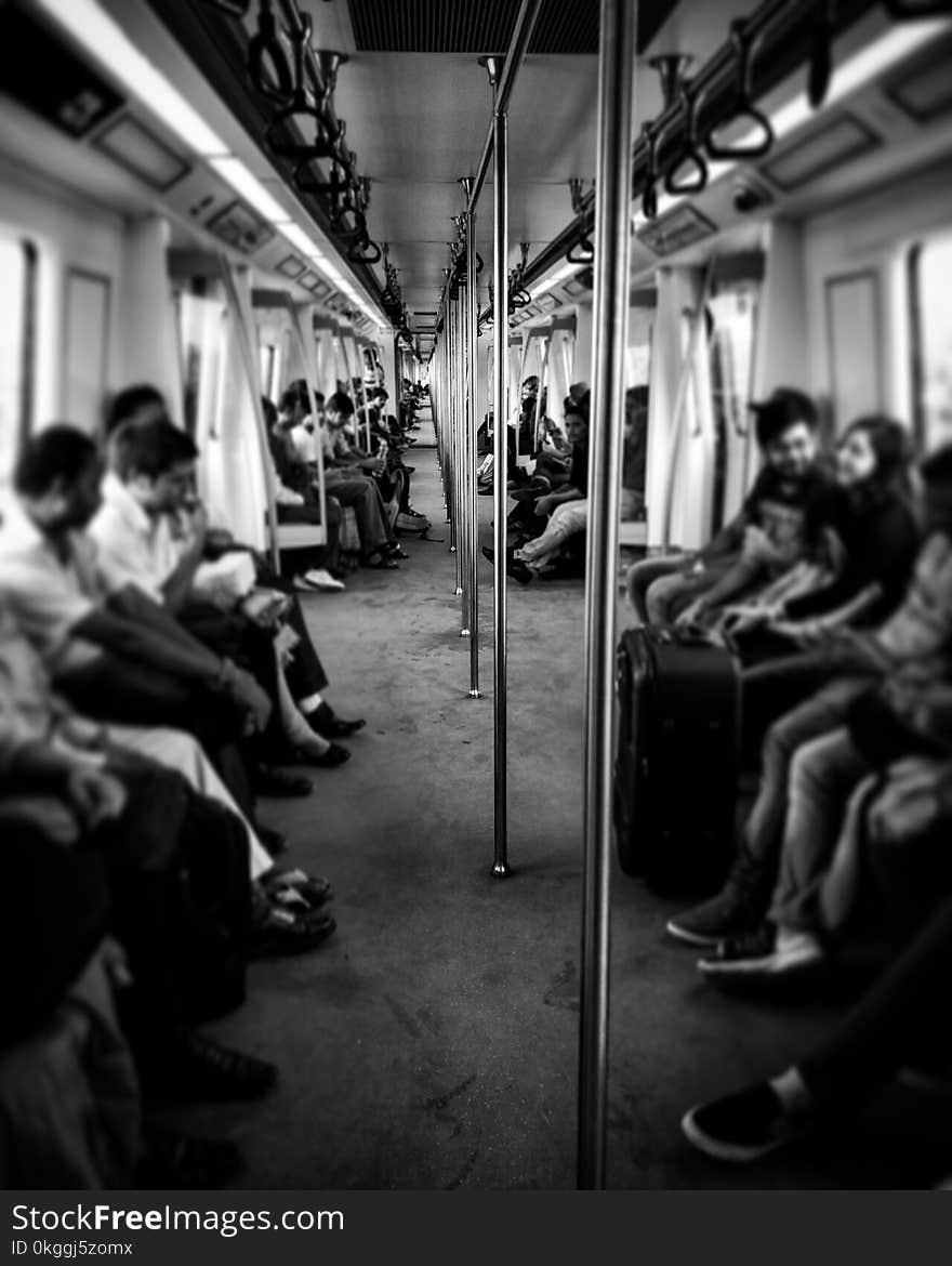 Grayscale Photography of Train Passengers