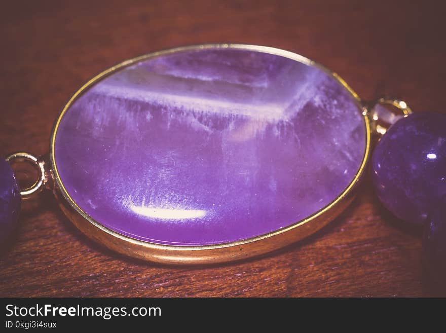 Fashion bracelet made of natural purple amethyst beads, filtered background. Fashion bracelet made of natural purple amethyst beads, filtered background.