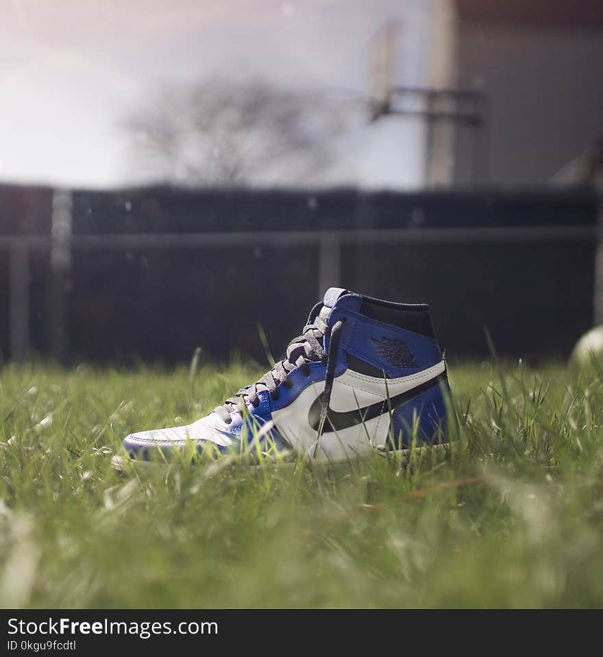 Selective Focus Photography of Air Jordan 1 On Grass