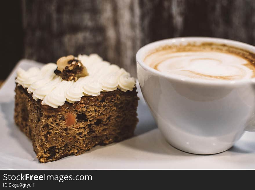 White Ceramic Teacup Near Baked Bread