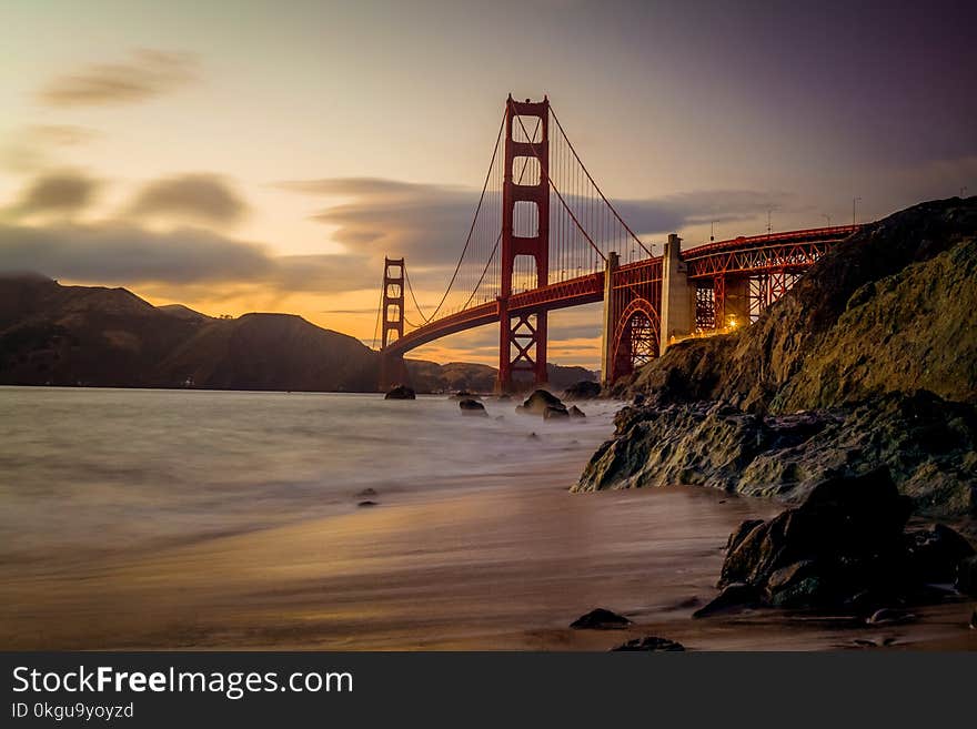 Photography of Red Bridge Under White and Gray Sky