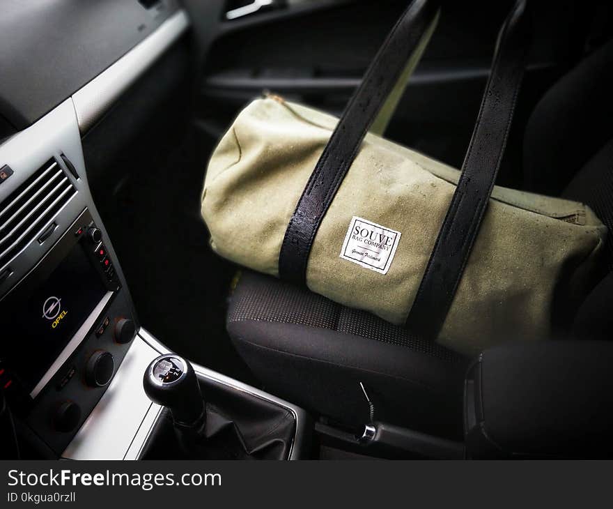 Brown and Black Duffel Bag on a Car Seat