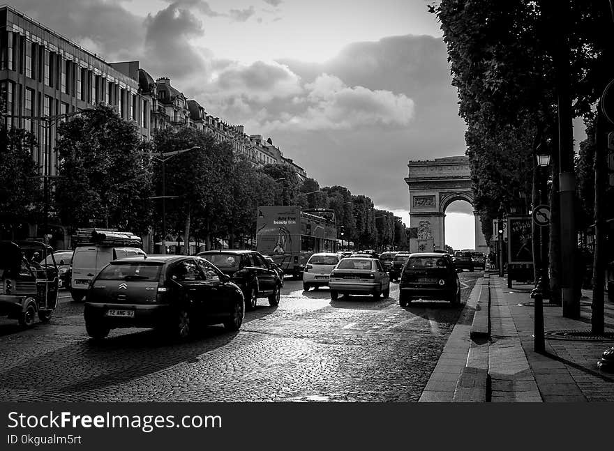 Grayscale Photo of Busy Streets With Building