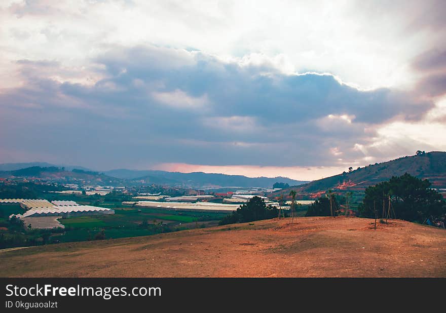 Brown Field Under White Cloudy Sky