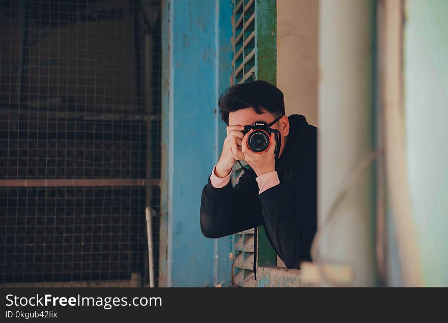 Person Holding Black Dslr Camera