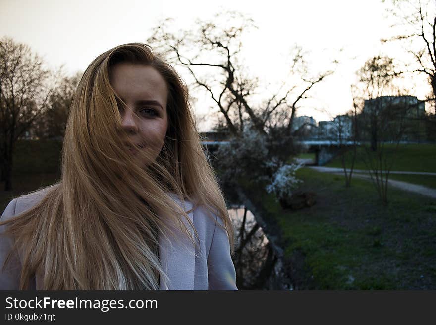 Woman Wearing White Winter Coat While Taking Selfie