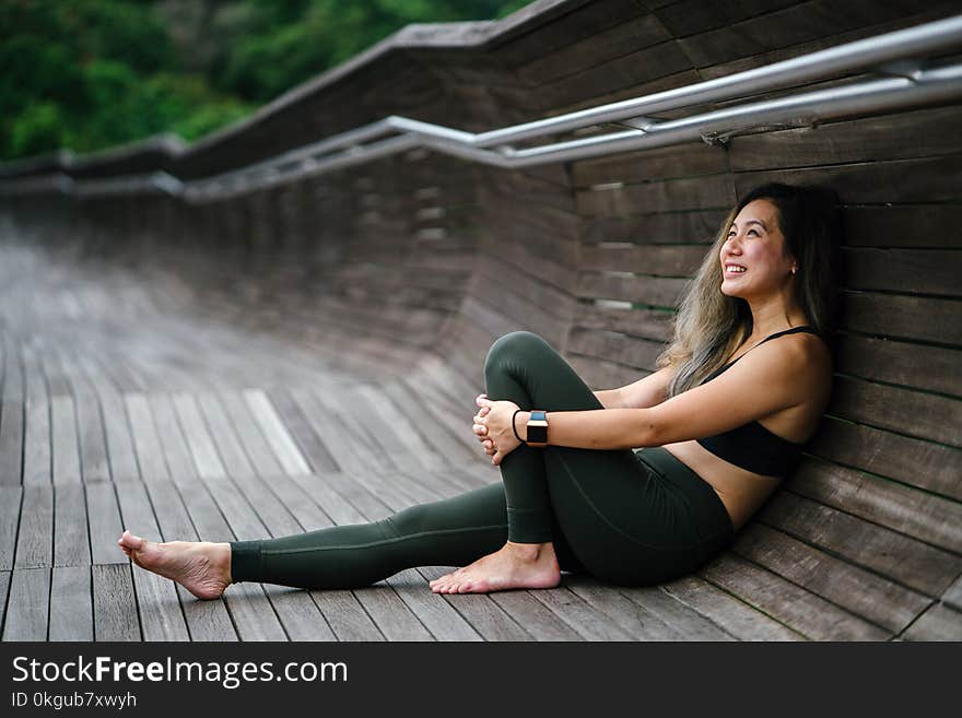 Photo of Smiling Woman Woman in Black Sports Bra and Black Leggings