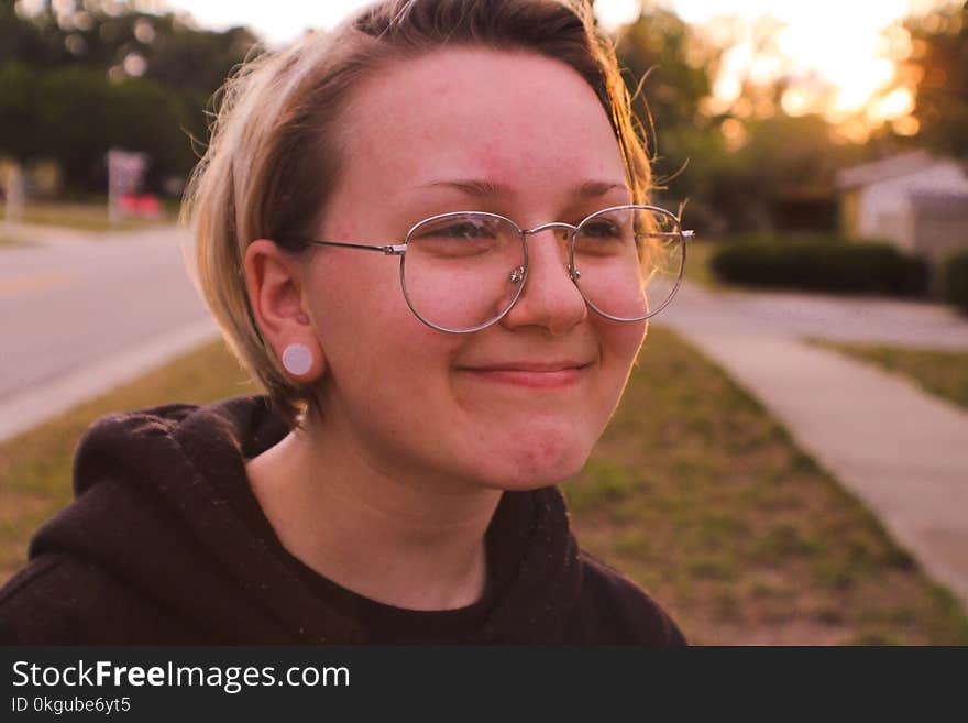 Woman Wearing Black Pullover Hoodie and Round Silver-colored Eyeglasses Smiling